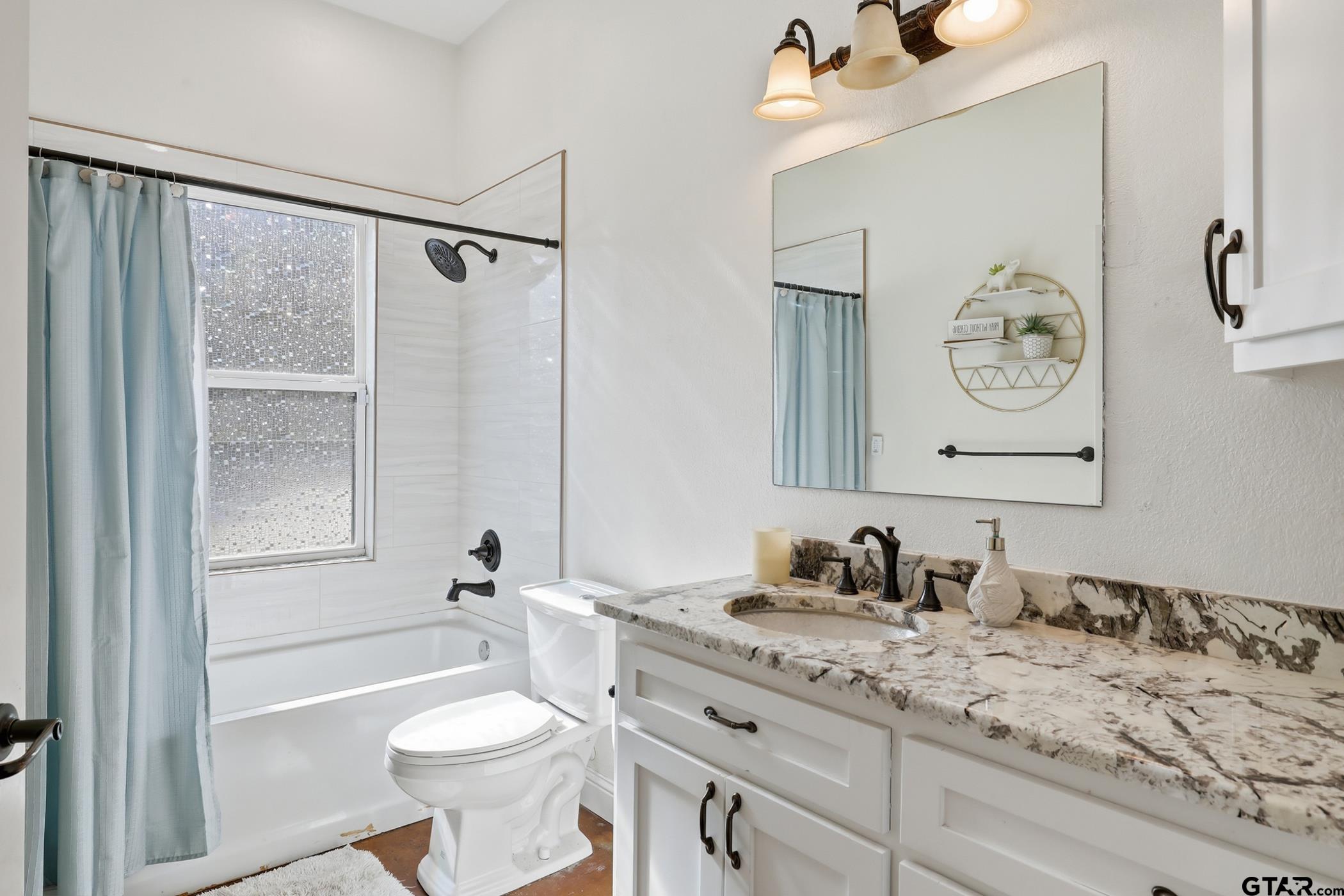 847 Calloway Road Marshall, TX 75670 - Photo 19 of 33 a bathroom with a granite countertop sink toilet and shower