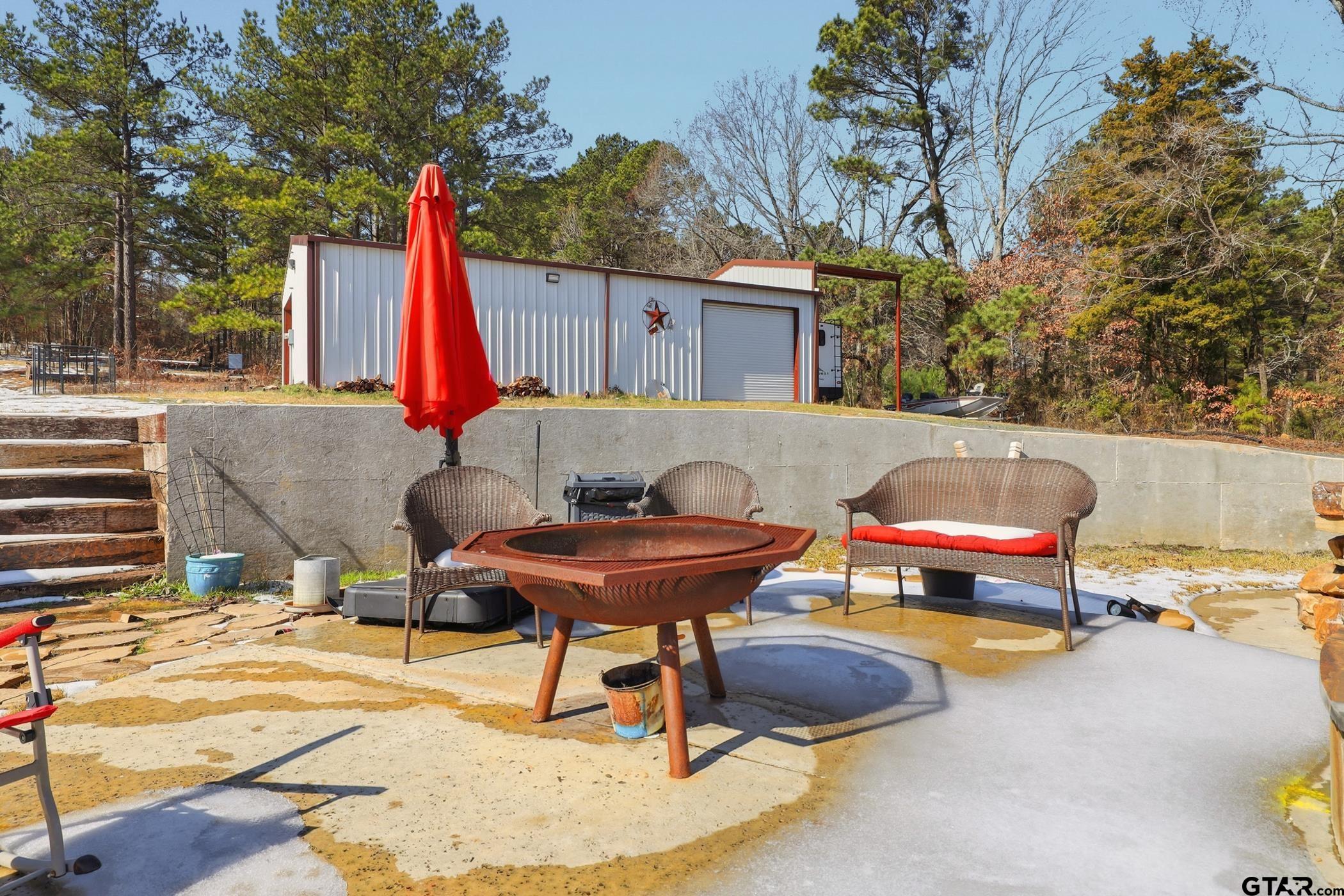 847 Calloway Road Marshall, TX 75670 - Photo 24 of 33 a swimming pool with barbeque oven table and chairs