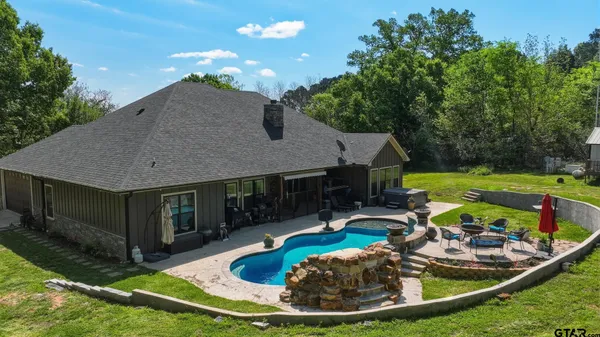 a view of a dining room with furniture and chandelier
