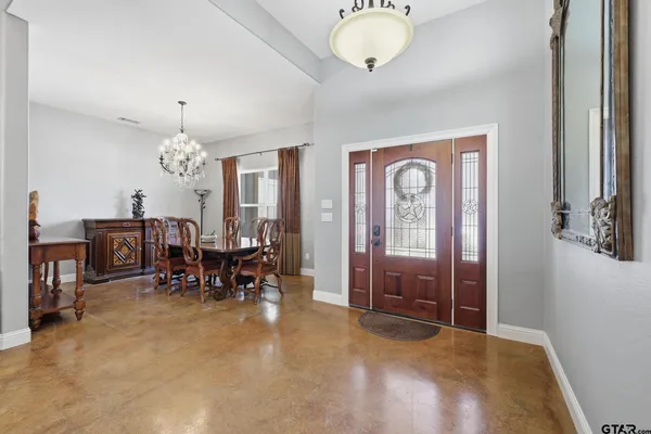 a living room with furniture and a chandelier