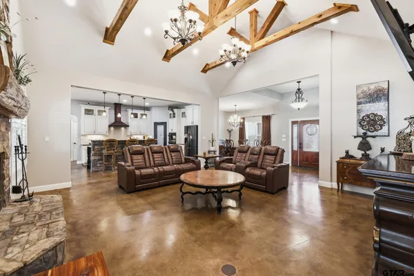 a living room with furniture and a mirror