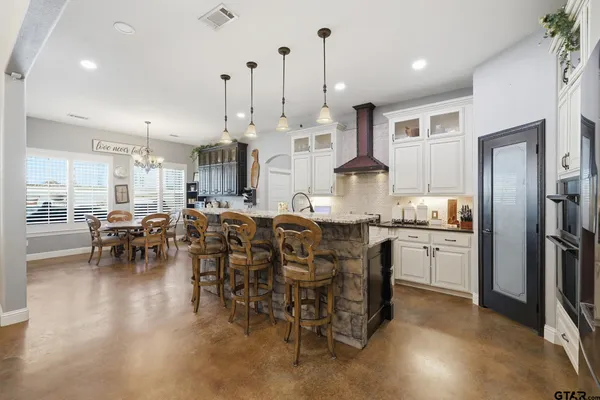 a bathroom with a granite countertop sink toilet a mirror a vanity and shower