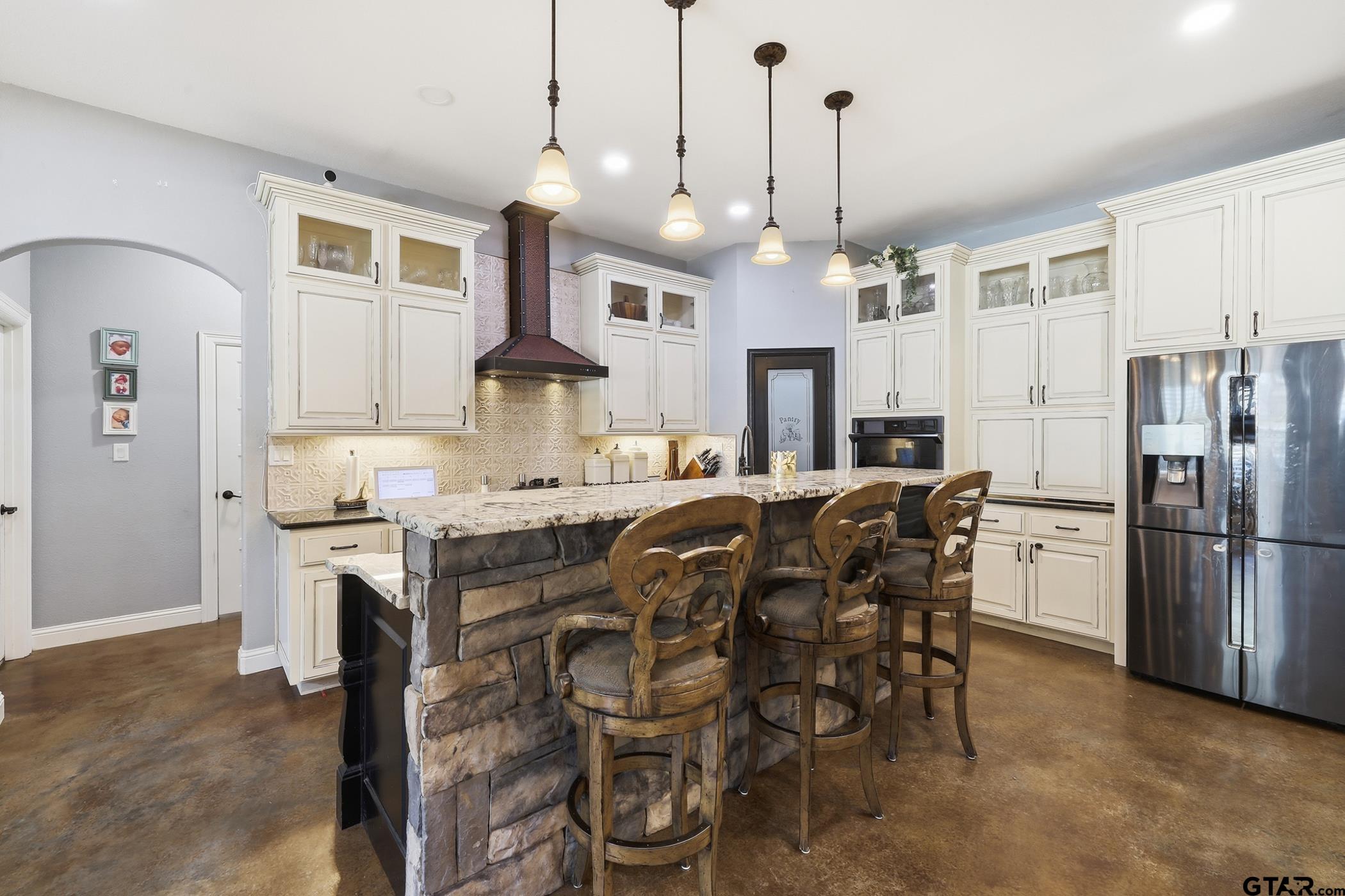 847 Calloway Road Marshall, TX 75670 - Photo 10 of 33 a kitchen with kitchen island granite countertop a table chairs refrigerator and microwave