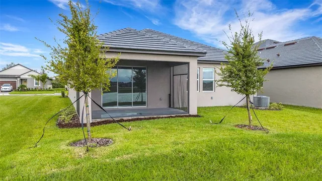 a large kitchen with stainless steel appliances a large counter top a stove a refrigerator and a sink