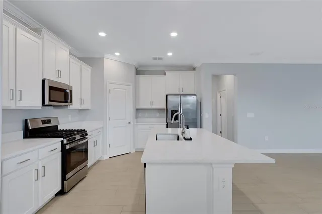 a kitchen with a refrigerator and cabinets