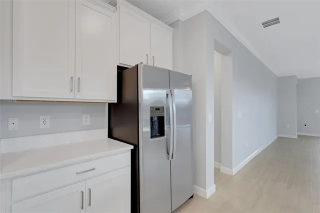 a view of an empty room with a kitchen