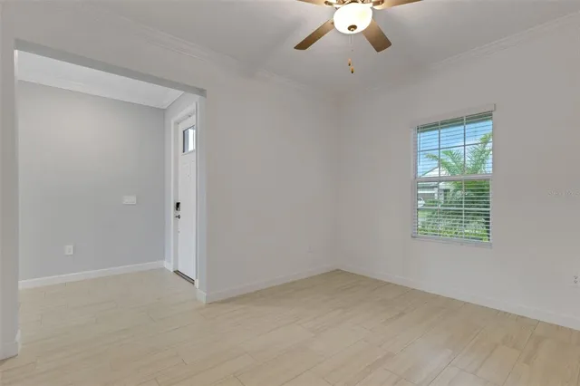 an empty room with a ceiling fan