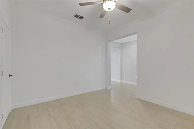 an empty room with a empty space and a ceiling fan