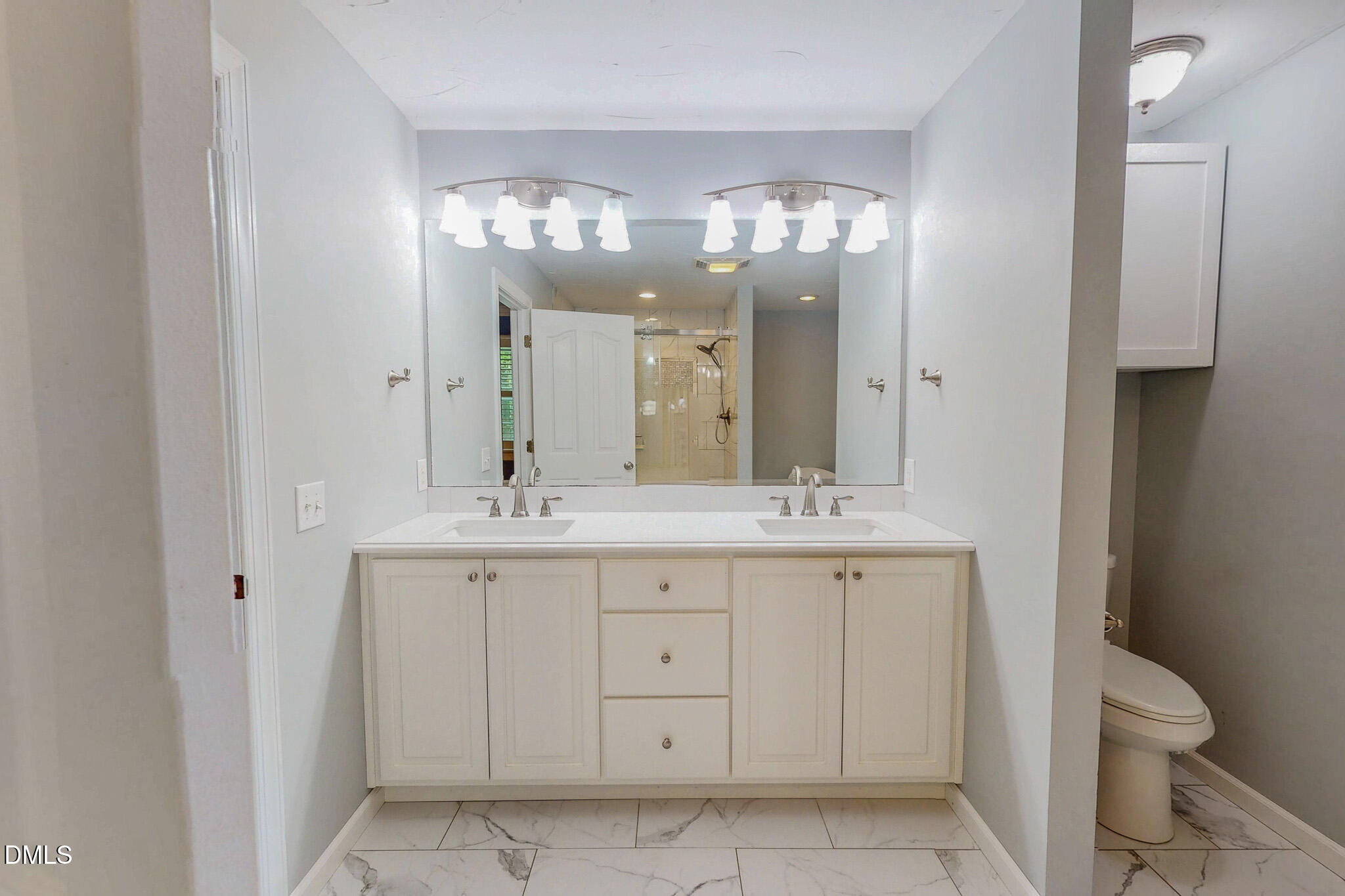 2428 Helena Moriah Road Timberlake, NC 27583 - Photo 24 of 73 a bathroom with a double vanity sink and a mirror