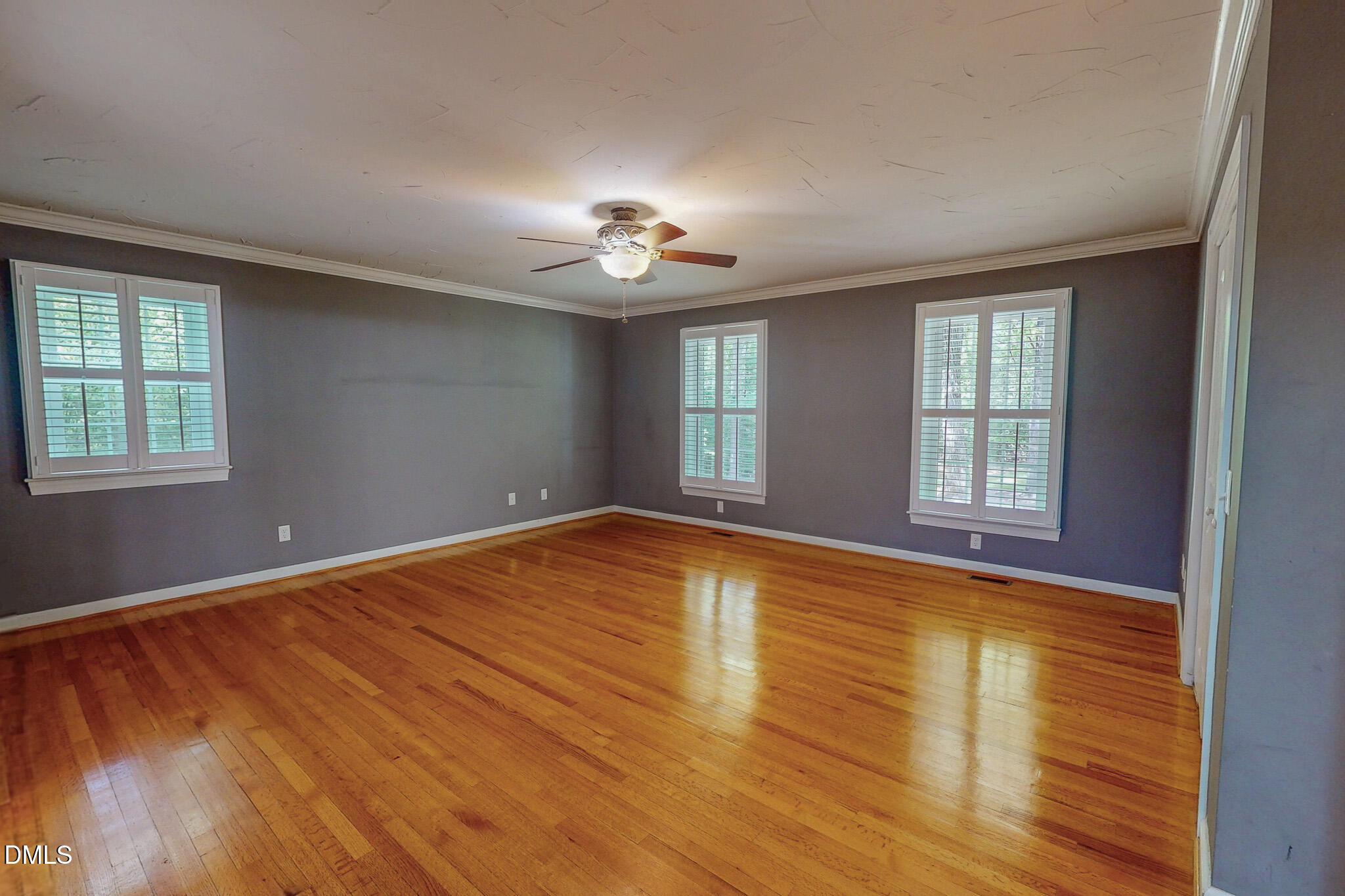 2428 Helena Moriah Road Timberlake, NC 27583 - Photo 28 of 73 a view of empty room with wooden floor and fan