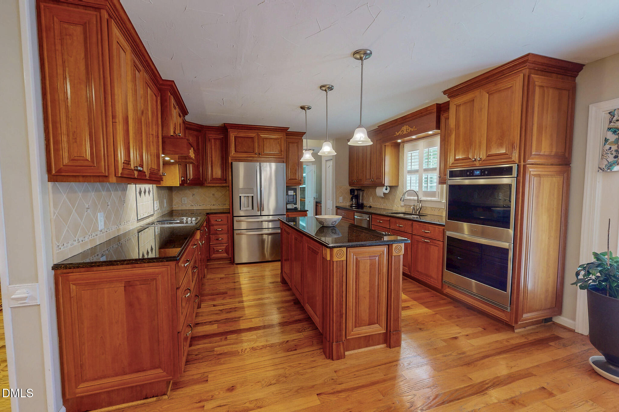 2428 Helena Moriah Road Timberlake, NC 27583 - Photo 3 of 73 a open kitchen with stainless steel appliances granite countertop a stove a sink dishwasher and a refrigerator with wooden floor