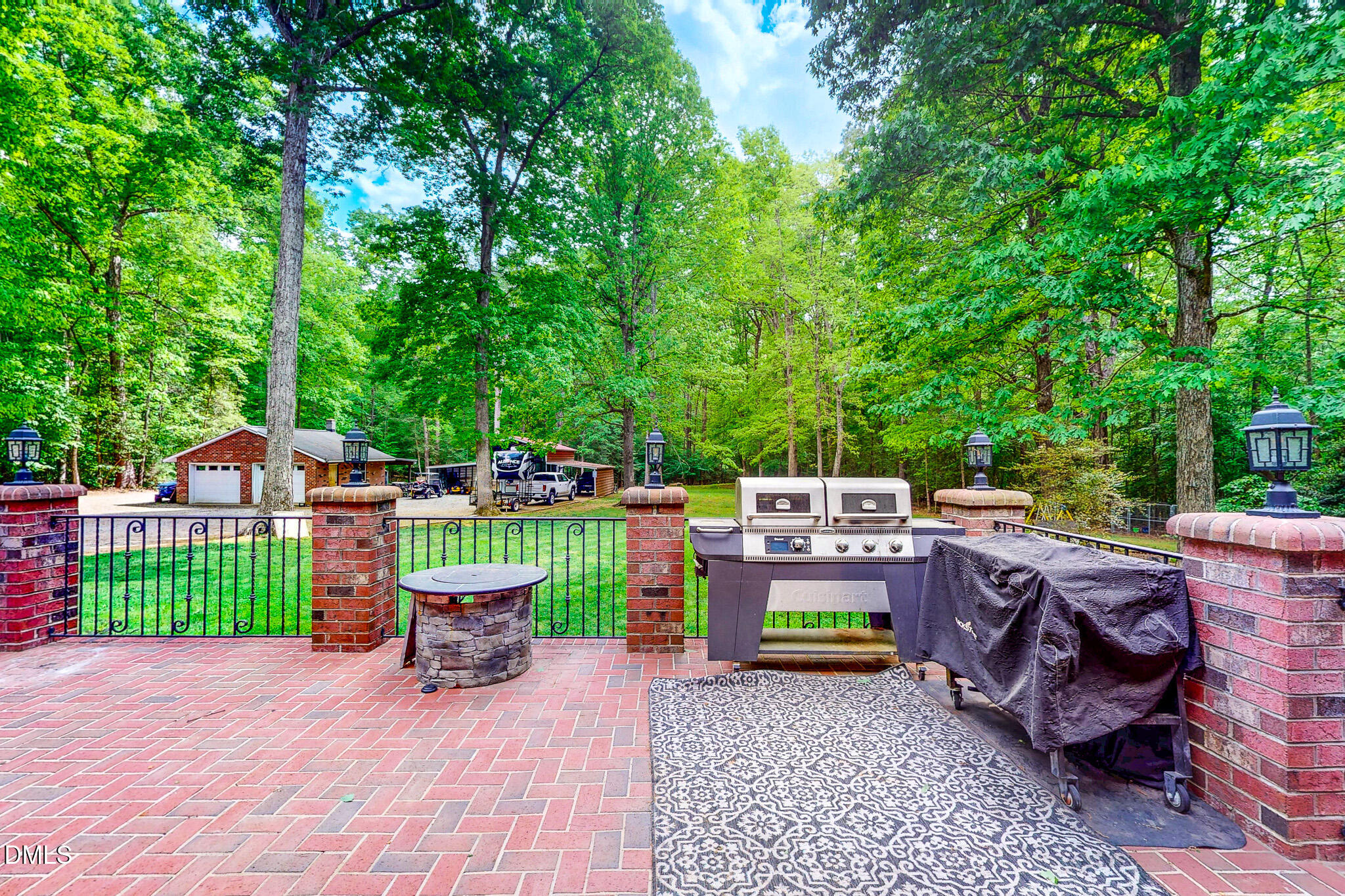 2428 Helena Moriah Road Timberlake, NC 27583 - Photo 35 of 73 a view of a patio with table and chairs potted plants and large tree