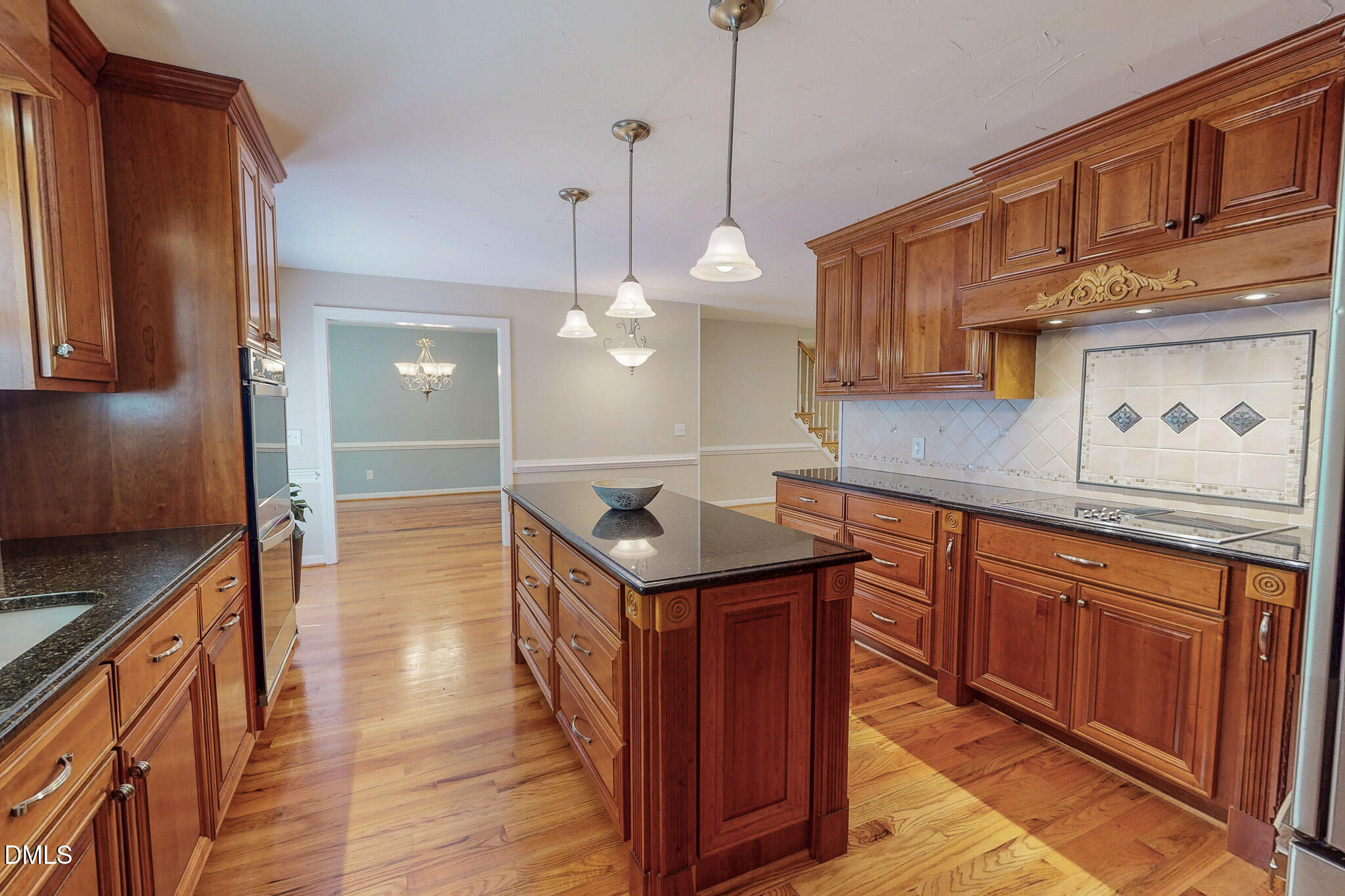 2428 Helena Moriah Road Timberlake, NC 27583 - Photo 4 of 73 a kitchen with stainless steel appliances granite countertop a sink a stove and a wooden floors