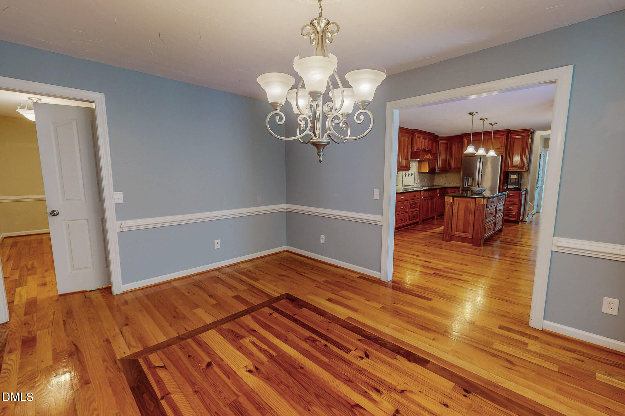 2428 Helena Moriah Road Timberlake, NC 27583 - Photo 45 of 73 a view of a room with wooden floor and chandelier