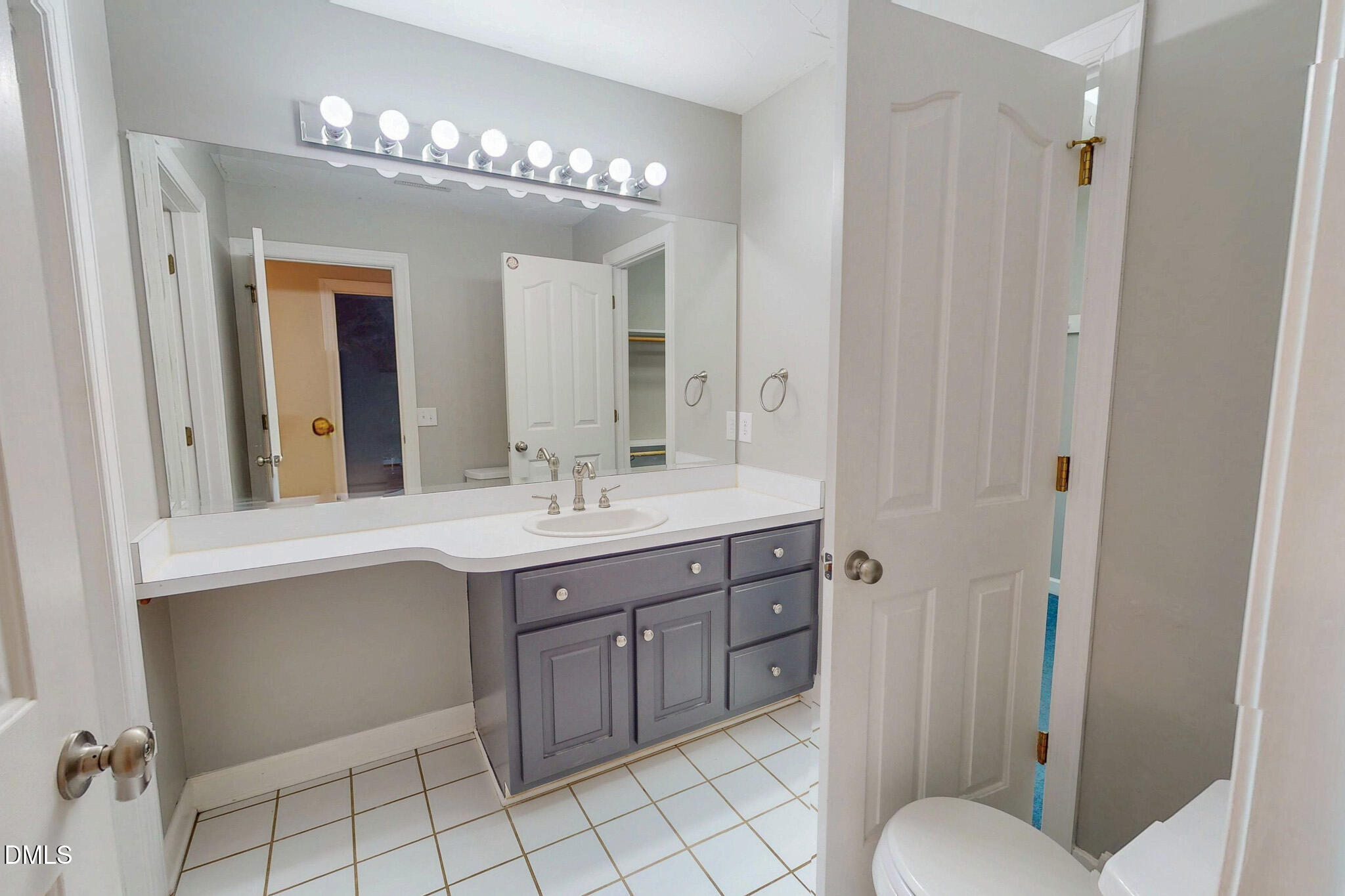 2428 Helena Moriah Road Timberlake, NC 27583 - Photo 55 of 73 a spacious bathroom with a granite countertop sink a toilet and a mirror