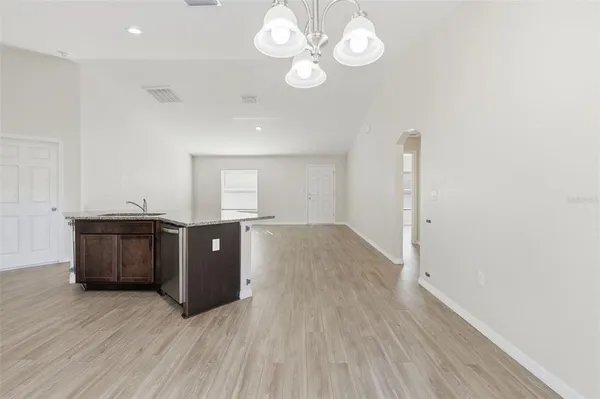 a view of a room with wooden floor
