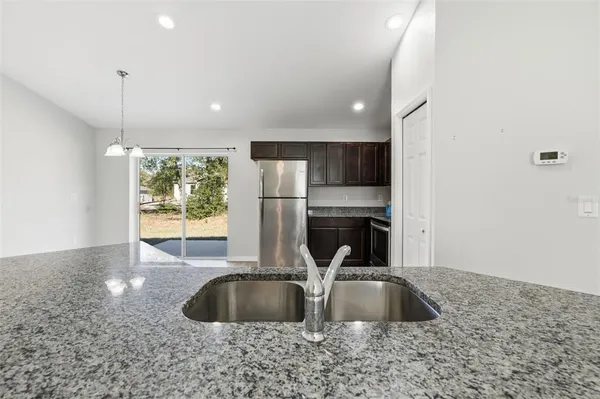 a kitchen with kitchen island a sink and a large window