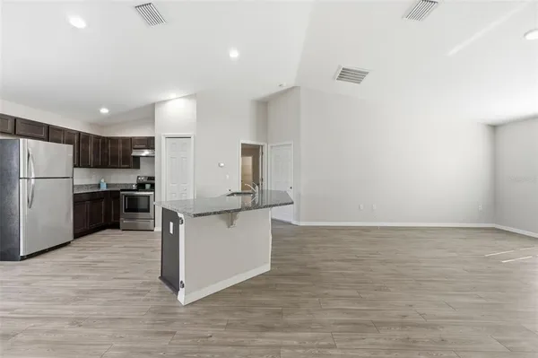 a kitchen with stainless steel appliances a refrigerator and a stove top oven