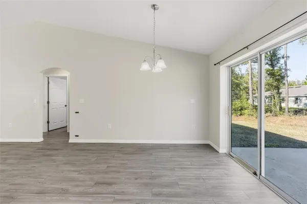 a view of a room with wooden floor and white walls