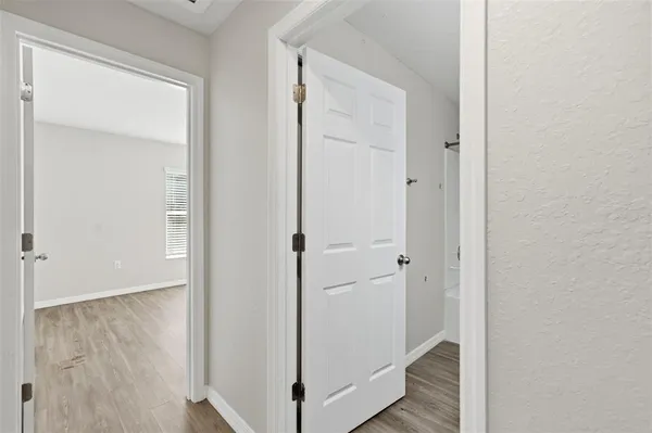 a view of a hallway with wooden floor