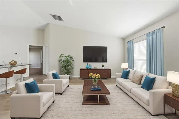 a living room with furniture and a flat screen tv