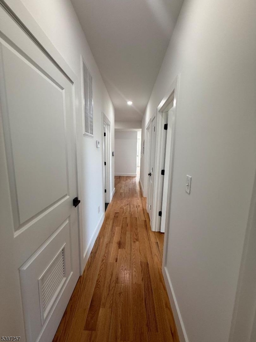 715 South 17th Street, Unit 2 Newark, NJ 07103 - Photo 14 of 24 a view of a hallway with wooden floor and staircase