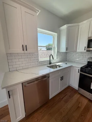a kitchen with a sink cabinets and window