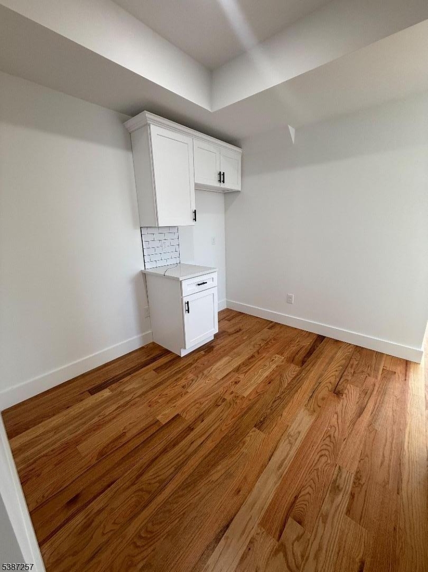 715 South 17th Street, Unit 2 Newark, NJ 07103 - Photo 6 of 24 a view of empty room with wooden floor
