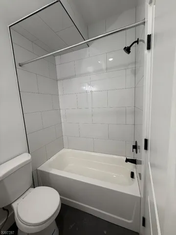 a bathroom with a bathtub and a toilet