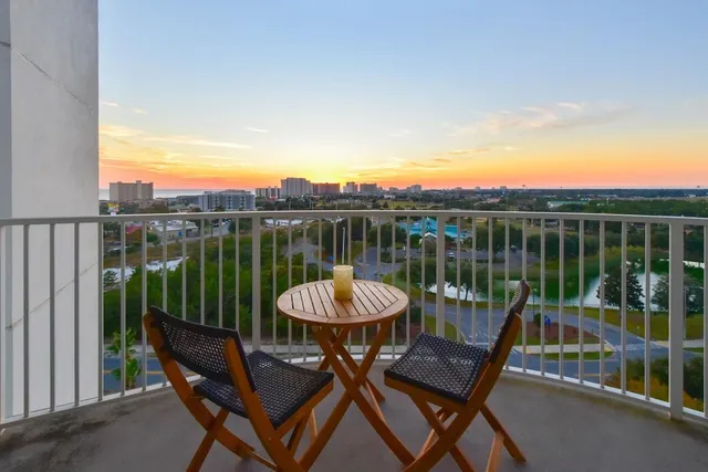 a view of a chairs and table in the balcony