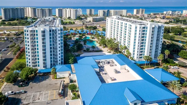 a view of a house with a swimming pool and a yard