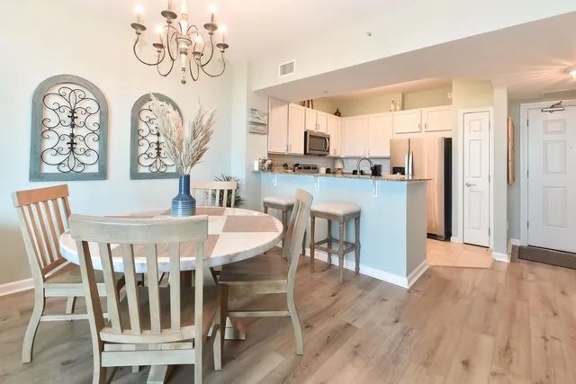 a view of a dining room with furniture and wooden floor