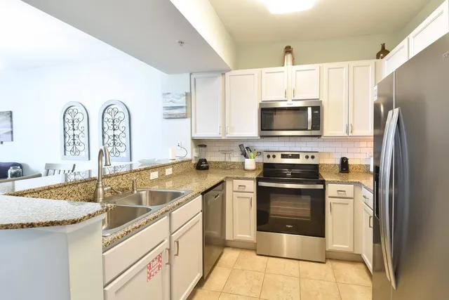 a kitchen with a sink stove and refrigerator