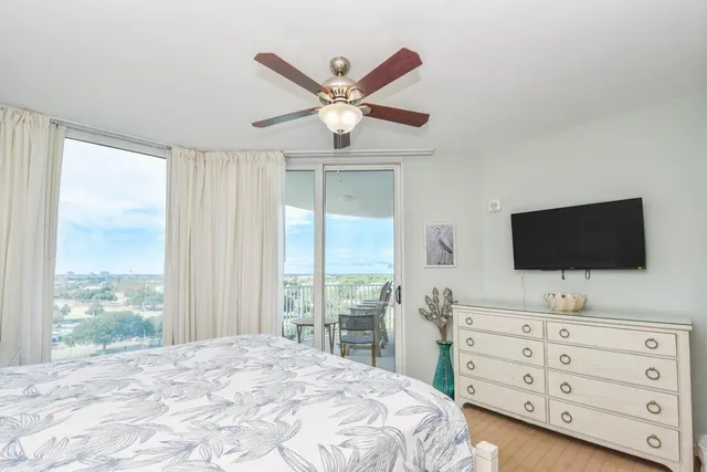 a bedroom with a large bed and a flat screen tv