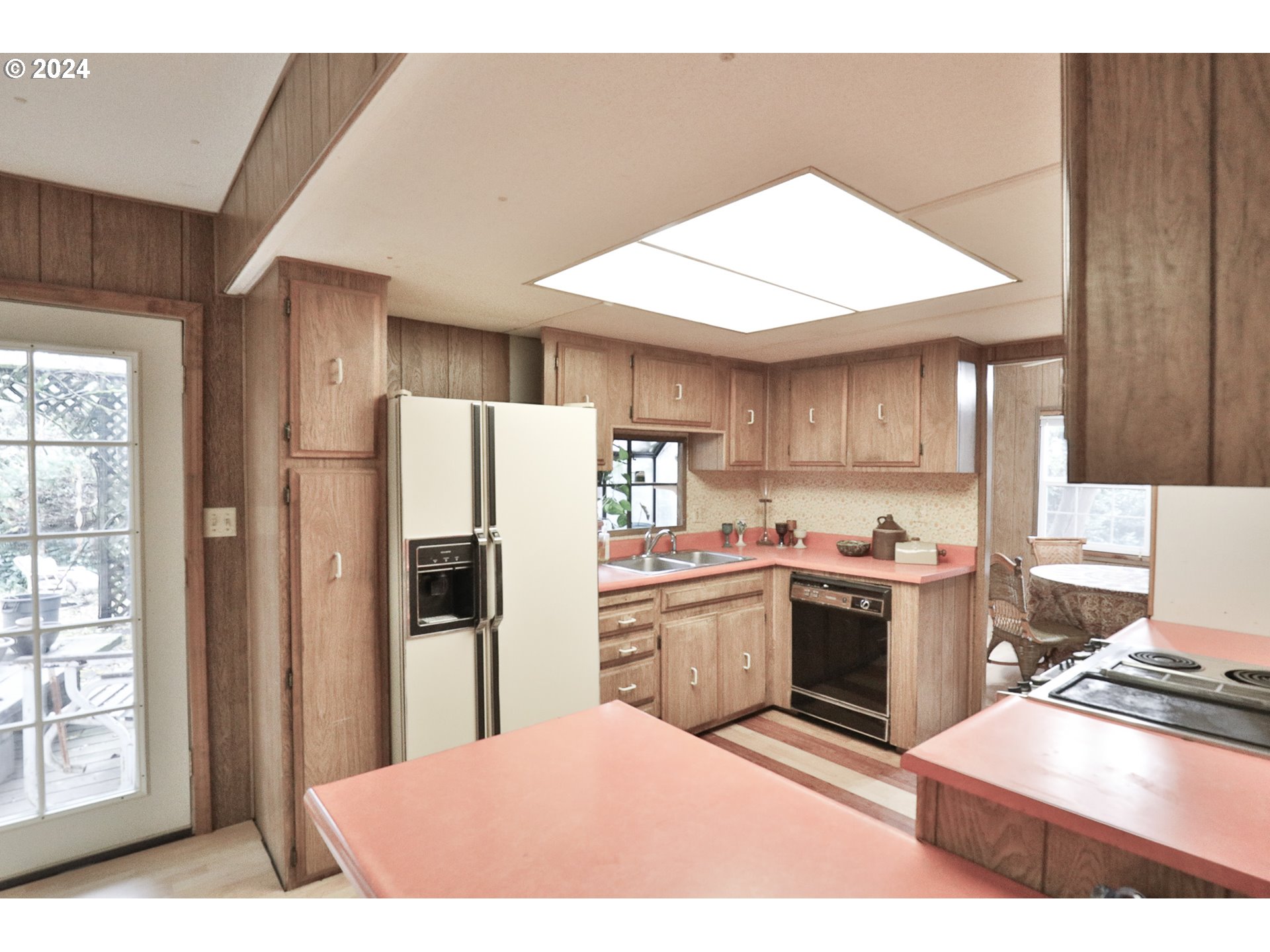 2073 Inland Way Springfield, OR 97477 - Photo 5 of 21 a kitchen with stainless steel appliances kitchen island granite countertop a refrigerator oven a sink dishwasher and white cabinets with wooden floor