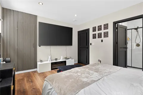 a bedroom with a bed and a flat screen tv