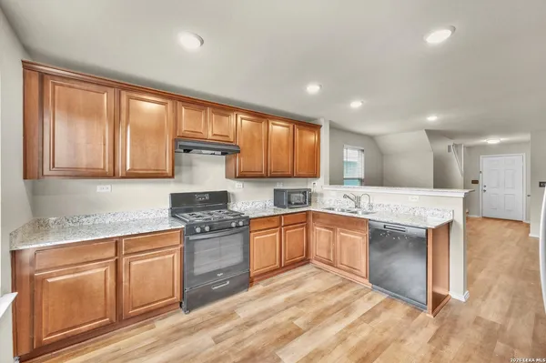 a kitchen with a stove a sink and a refrigerator