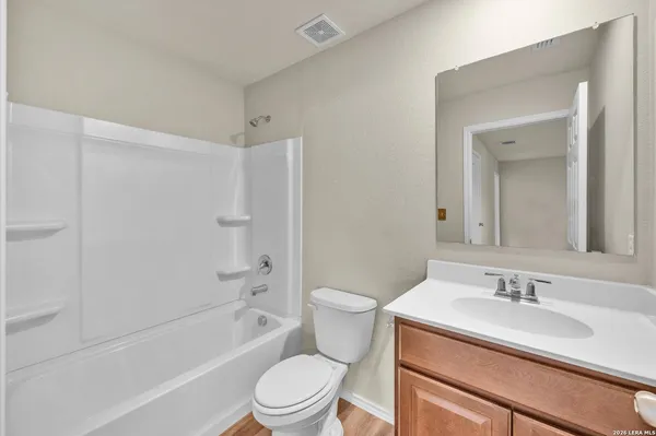 a bathroom with a sink toilet vanity and shower