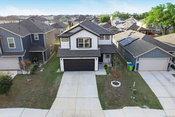 an aerial view of a house with yard