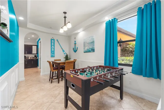 a kitchen with stainless steel appliances granite countertop a stove a sink a oven a dining table and chairs