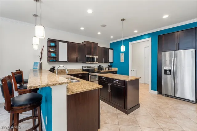a view of a dining room and livingroom with furniture a chandelier