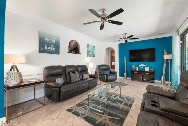 a living room with furniture and a ceiling fan