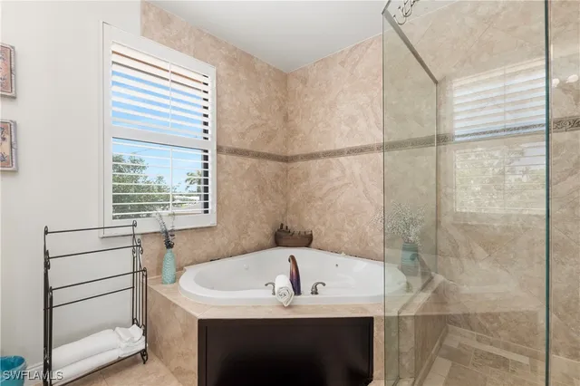 a living room with furniture kitchen view and a large window