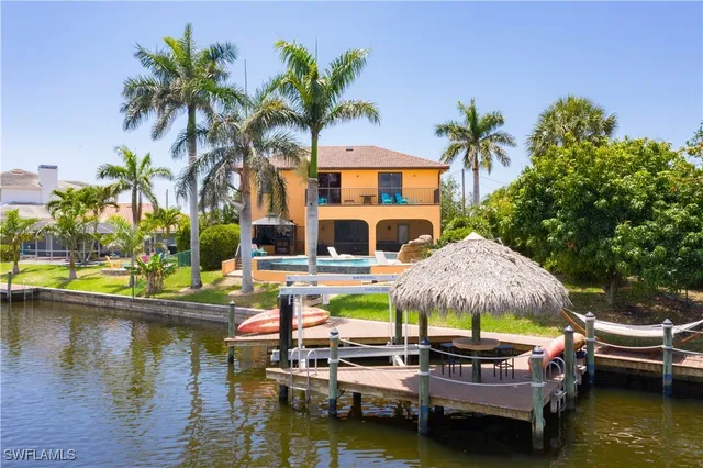 a view of a house with swimming pool and sitting area