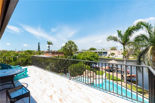 a view of lake from balcony having outdoor seating