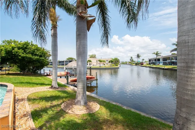 a dining table with a large window and outdoor space