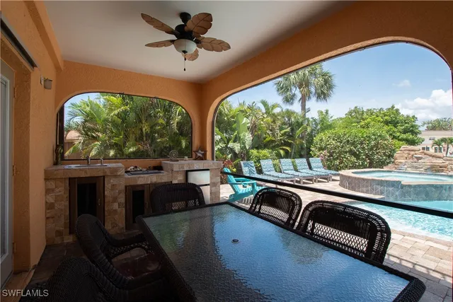 a view of a porch with furniture and a yard