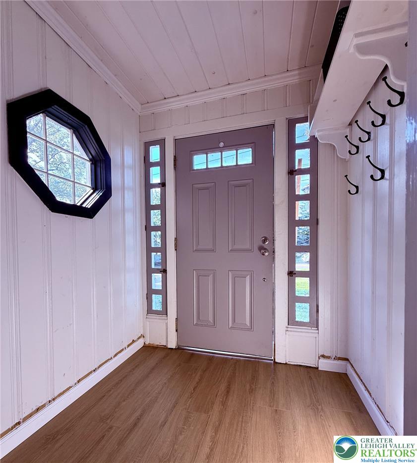1275 Macada Road Bethlehem, PA 18017 - Photo 17 of 87 A welcoming entry features a stylish door flanked by tall windows and natural-toned flooring.