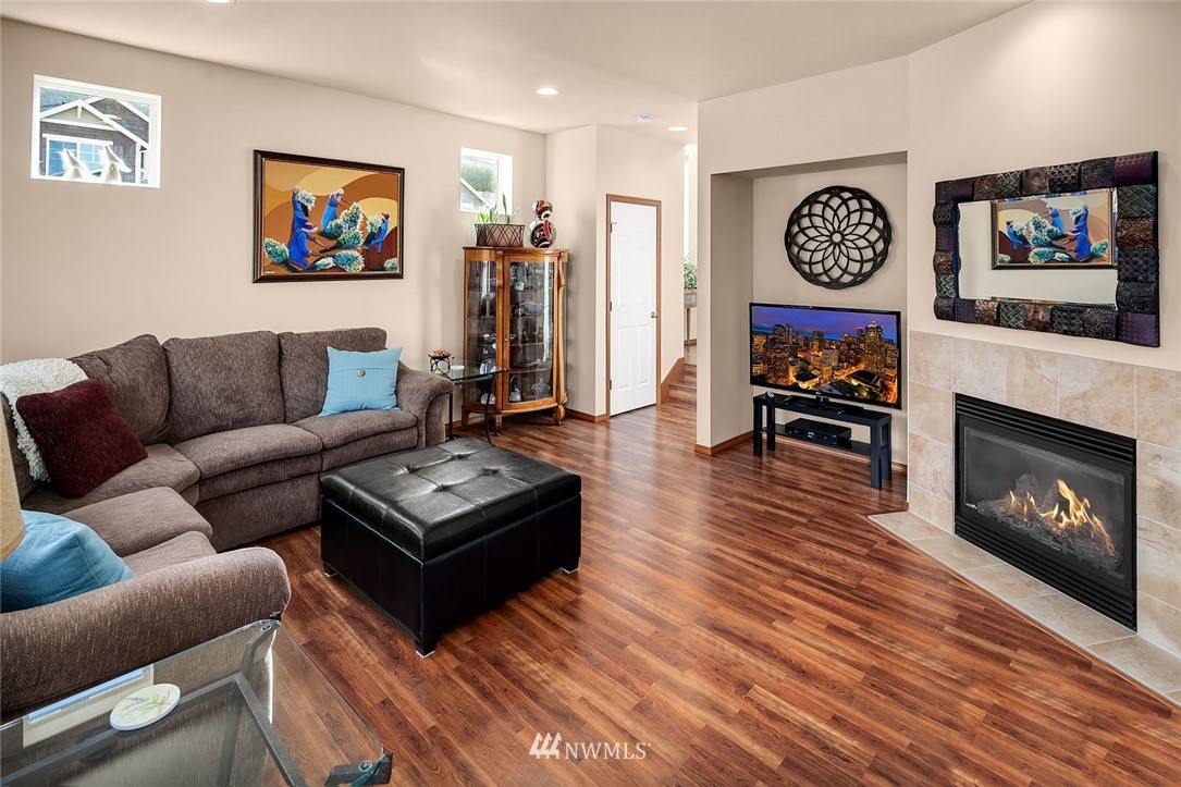 23019 42nd Drive Southeast Bothell, WA 98021 - Photo 2 of 19 a living room with furniture a flat screen tv and a fireplace