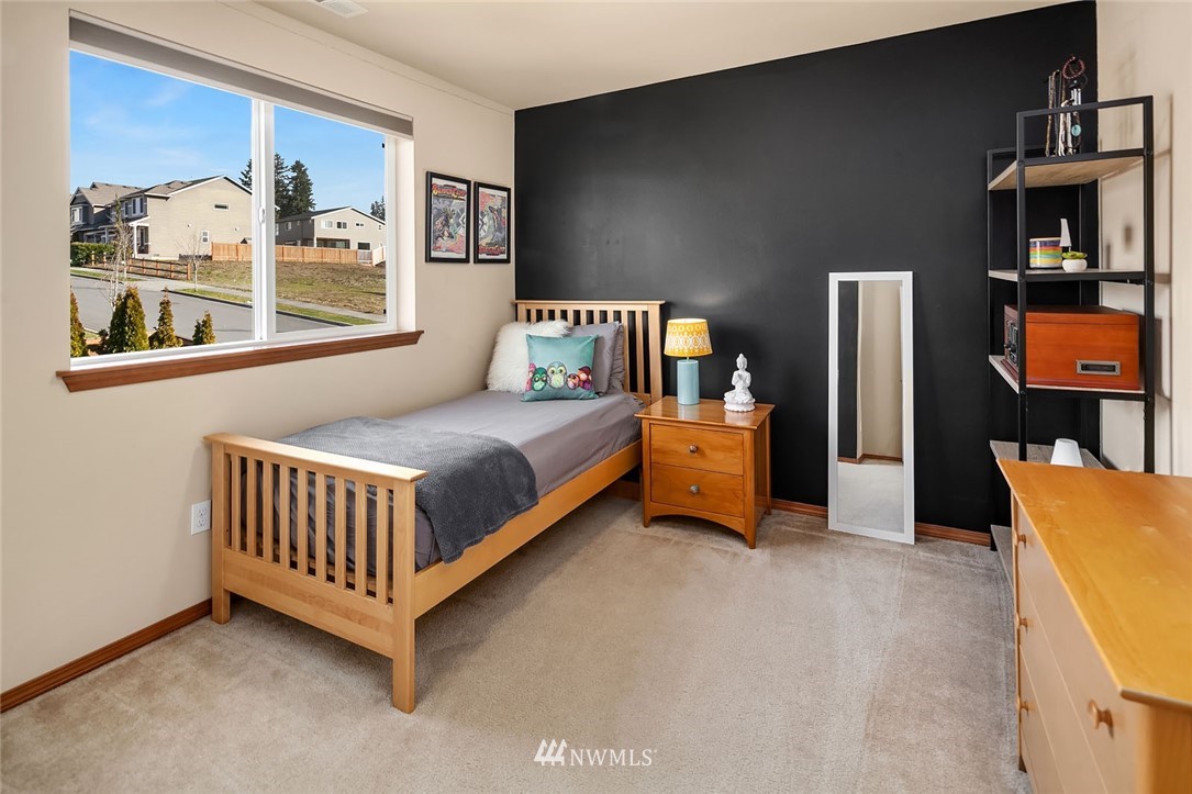 23019 42nd Drive Southeast Bothell, WA 98021 - Photo 13 of 19 a bedroom with a bed and wooden floor